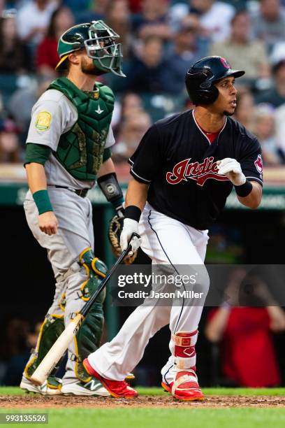 Catcher Jonathan Lucroy of the Oakland Athletics watches as Michael Brantley of the Cleveland Indians hits an RBI double during the fifth inning at...