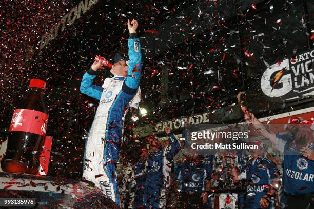Kyle Larson, driver of the DC Solar Chevrolet, celebrates in Victory Lane after winning the NASCAR Xfinity Series Coca-Cola Firecracker 250 at...
