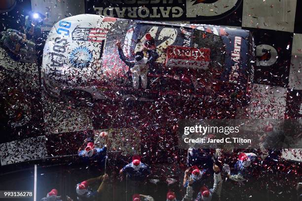 Kyle Larson, driver of the DC Solar Chevrolet, celebrates in Victory Lane after winning the NASCAR Xfinity Series Coca-Cola Firecracker 250 at...