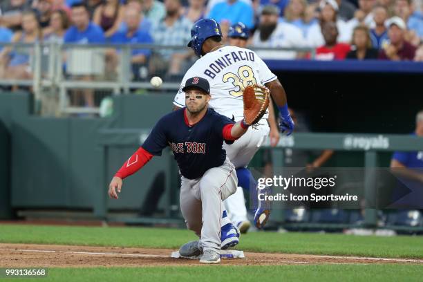 Kansas City Royals right fielder Jorge Bonifacio beats the throw to first baseman Boston Red Sox left fielder Steve Pearce for an infield single in...