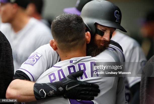 Charlie Blackmon of the Colorado Rockies hugs Gerardo Parra after hitting a home run off of Felix Hernandez of the Seattle Mariners in the first...