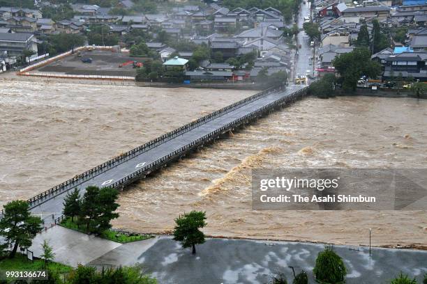In this aerial image, Swollen Katsuragawa River and Togetsukyo Bridge are seen as heavy rain continues on July 6, 2018 in Kyoto, Japan. At least one...