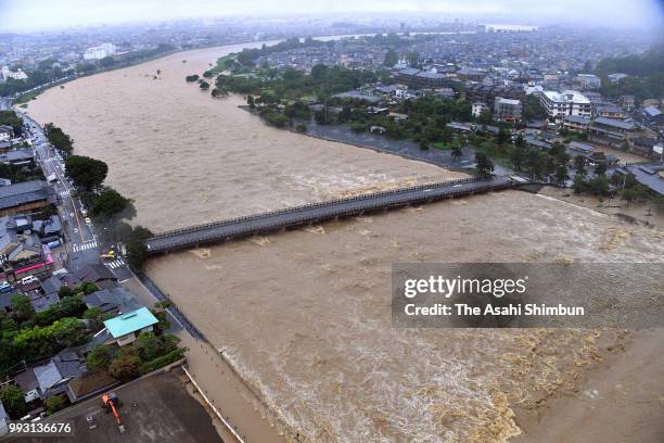 In this aerial image, Swollen Katsuragawa River and Togetsukyo Bridge are seen as heavy rain continues on July 6, 2018 in Kyoto, Japan. At least one...
