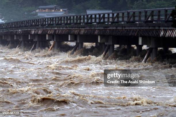 Water level of swollen Katsuragawa River nearly reaches to Togetsukyo Bridge as heavy rain continues on July 6, 2018 in Kyoto, Japan. At least one...