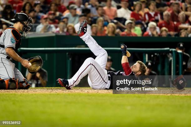 Mark Reynolds of the Washington Nationals dodges an inside pitch in front of J.T. Realmuto of the Miami Marlins during the ninth inning at Nationals...