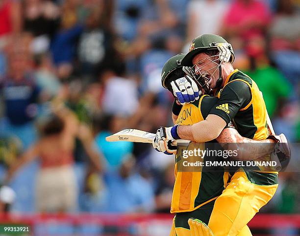 Australian batsman Michael Hussey celebrates with Mitchell Johnson after hitting the winning run during the ICC World Twenty20 second semifinal match...