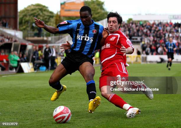 Lloyd Sam of Charlton is tackled by Alan Sheehan of Swindon during the Coca-Cola League One Playoff Semi Final 1st leg match between Swindon Town and...