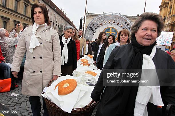 Women distribute blessed bread after the celebration of Greek orthodox vespers during day 3 of the 2nd Ecumenical Church Day at Odeonsplatz square on...