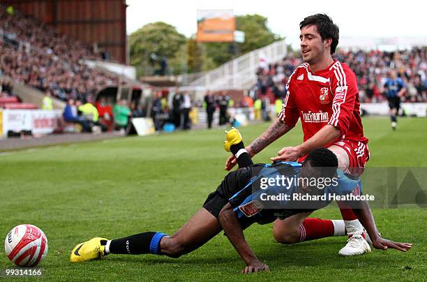 Lloyd Sam of Charlton is tackled by Alan Sheehan of Swindon during the Coca-Cola League One Playoff Semi Final 1st leg match between Swindon Town and...