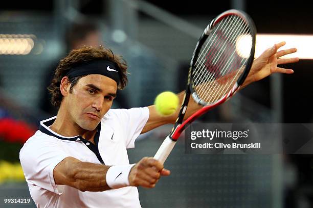 Roger Federer of Switzerland plays a backhand against Ernests Gulbis of Latvia in their quarter final match during the Mutua Madrilena Madrid Open...