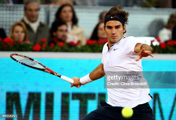 Roger Federer of Switzerland plays a forehand against Ernests Gulbis of Latvia in their quarter final match during the Mutua Madrilena Madrid Open...
