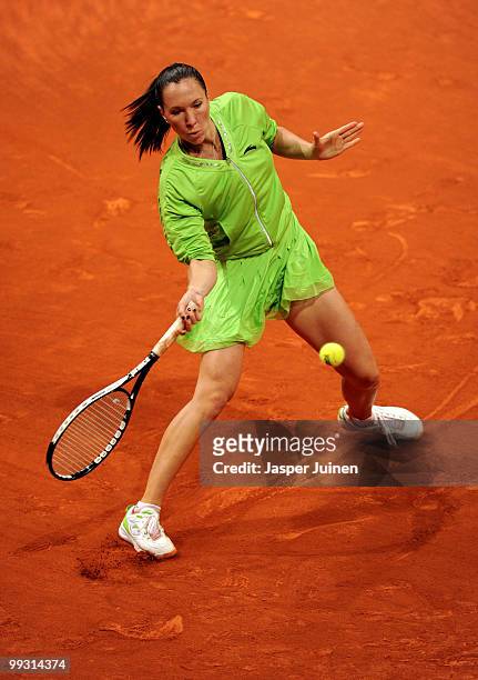 Jelena Jankovic of Serbia plays a backhand to Aravane Rezai of France in her quarter final match during the Mutua Madrilena Madrid Open tennis...