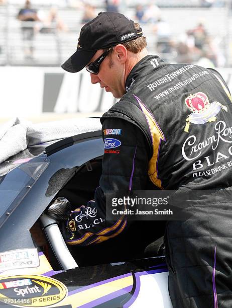 Matt Kenseth, driver of the Crown Royal Black Ford, stands by his car on the grid during qualifying for the NASCAR Sprint Cup Series Autism Speaks...