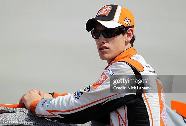 Joey Logano, driver of the The Home Depot Toyota, stands on the grid during qualifying for the NASCAR Sprint Cup Series Autism Speaks 400 at Dover...