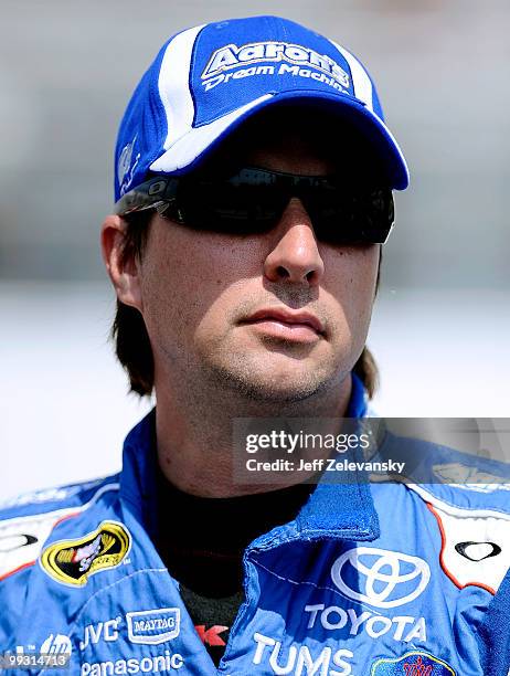 David Reutimann driver of the Aaron's Dream Machine Toyota stands on the grid during qualifying for the NASCAR Sprint Cup Series Autism Speaks 400 at...