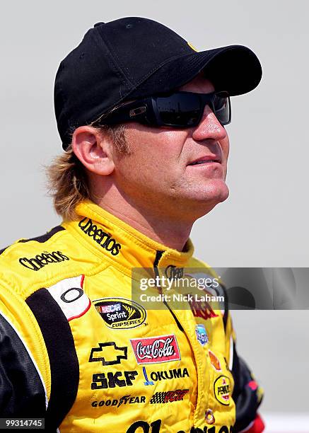 Clint Bowyer, driver of the Cheerios/Hamburger Helper Chevrolet, stands on the grid during qualifying for the NASCAR Sprint Cup Series Autism Speaks...