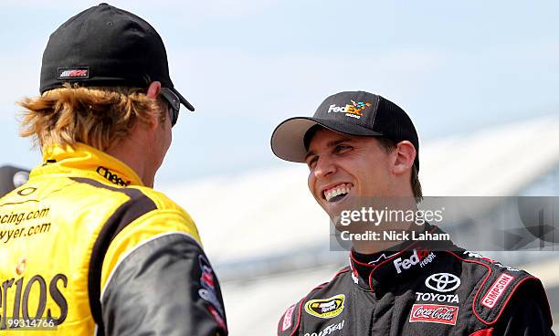 Clint Bowyer , driver of the Cheerios/Hamburger Helper Chevrolet, talks with Denny Hamlin, driver of the FedEx Freight Toyota, on the grid during...