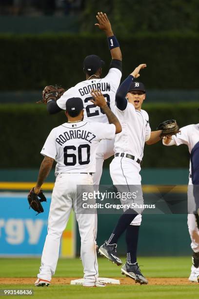 JaCoby Jones of the Detroit Tigers celebrates a 3-1 win over the Texas Rangers with Niko Goodrum and Ronny Rodriguez at Comerica Park on July 6, 2018...