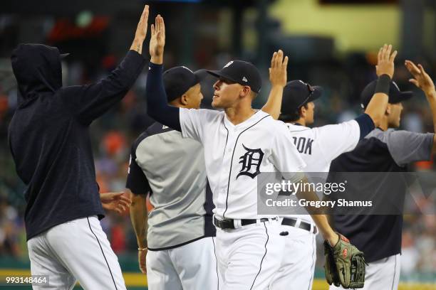 JaCoby Jones of the Detroit Tigers celebrates a 3-1 win over the Texas Rangers with teammates at Comerica Park on July 6, 2018 in Detroit, Michigan.