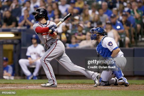 Dansby Swanson of the Atlanta Braves hits a double in the seventh inning against the Milwaukee Brewers at Miller Park on July 6, 2018 in Milwaukee,...