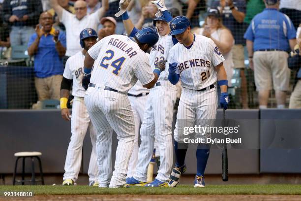 Jesus Aguilar and Travis Shaw of the Milwaukee Brewers celebrate after Aguilar hit a home run in the third inning against the Atlanta Braves at...