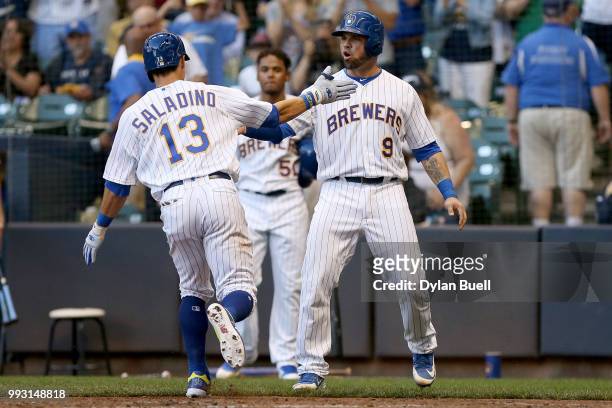 Tyler Saladino and Manny Pina of the Milwaukee Brewers celebrate after Saladino hit a home run in the third inning against the Atlanta Braves at...