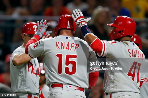 Andrew Knapp of the Philadelphia Phillies celebrates with Carlos Santana after hitting a three run home run in the seventh inning against the...