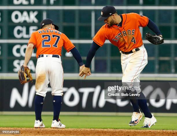 Jose Altuve of the Houston Astros and George Springer celebrate a win over the Chicago White Sox at Minute Maid Park on July 6, 2018 in Houston,...