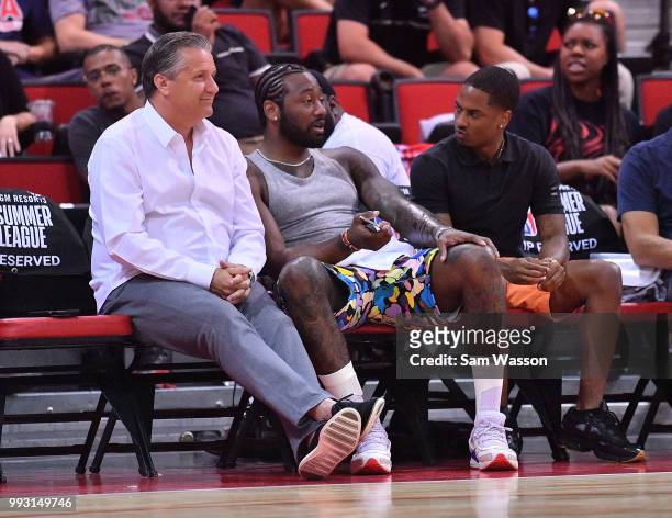 John Calipari head coach of the Kentucky Wildcats and John Wall of the Washington Wizards watch a game between the the Cleveland Cavaliers and the...