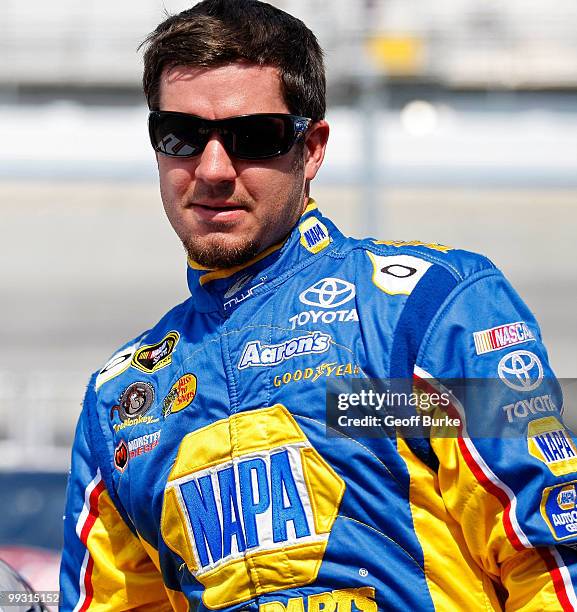 Martin Truex Jr., driver of the NAPA Auto Parts Toyota, gets out of his car after qualifying for the pole position in the NASCAR Sprint Cup Series...