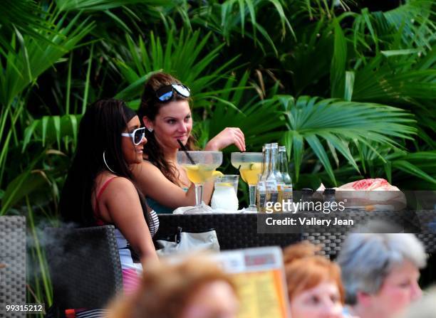 Nicole "Snooki" Polizzi and a friend are seen drinking and smoking cigarette on May 13, 2010 in Miami Beach, Florida.
