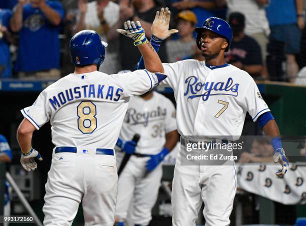 Mike Moustakas of the Kansas City Royals celebrates his two-run home run with Rosell Herrera in the eighth inning against the Boston Red Sox at...