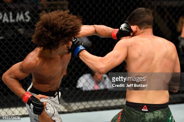 Alex Caceres and Martin Bravo of Mexico trade punches in their featherweight bout during The Ultimate Fighter Finale event inside The Pearl concert...