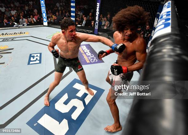 Martin Bravo of Mexico punches Alex Caceres in their featherweight bout during The Ultimate Fighter Finale event inside The Pearl concert theater at...