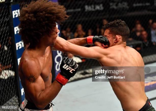 Martin Bravo of Mexico and Alex Caceres trade punches in their featherweight bout during The Ultimate Fighter Finale event inside The Pearl concert...