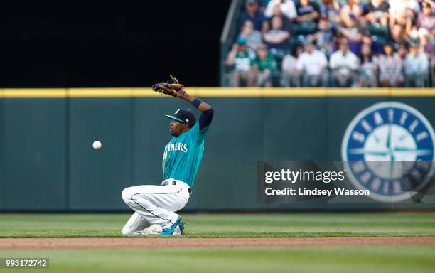 Dee Gordon of the Seattle Mariners can't grab the hit by Ian Desmond of the Colorado Rockies in the fourth inning at Safeco Field on July 6, 2018 in...