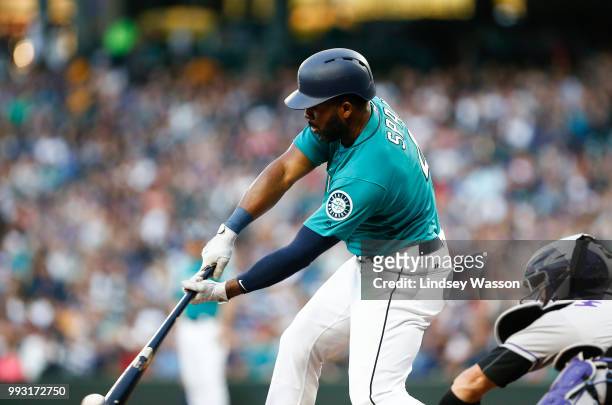 Denard Span of the Seattle Mariners chips a ball for a single in the fourth inning against the Colorado Rockies at Safeco Field on July 6, 2018 in...