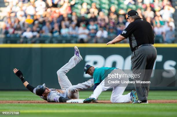 Trevor Story of the Colorado Rockies is called safe at second, beating the tag by Jean Segura of the Seattle Mariners in the third inning at Safeco...
