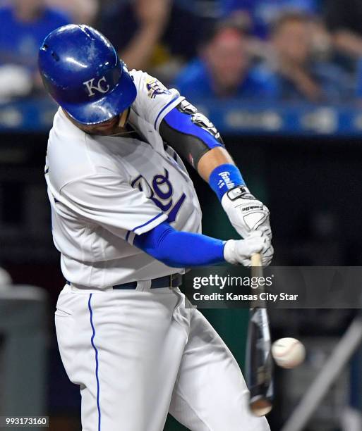 The Kansas City Royals' Whit Merrifield connects on an RBI single to score Adalberto Mondesi in the ninth inning against the Boston Red Sox on...