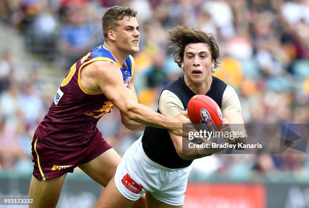 Caleb Marchbank of Carlton gets a handball away during the round 16 AFL match between the Brisbane Lions and the Carlton Blues at The Gabba on July...