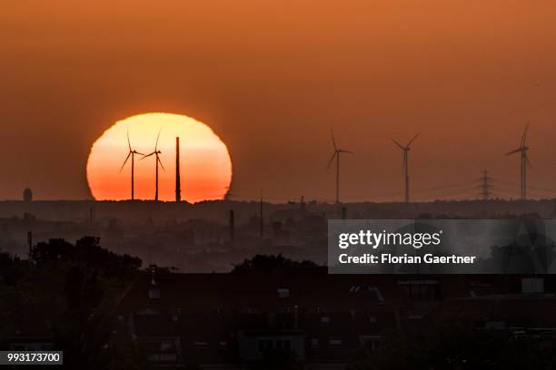 The sun rises behind wind turbines on July 07, 2018 in Berlin, Germany.