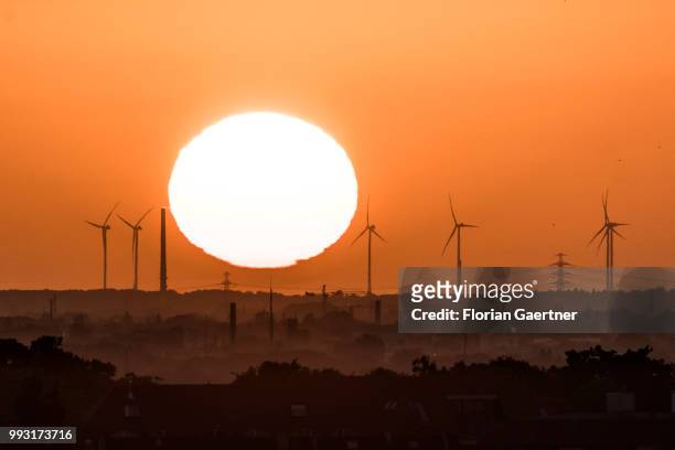 The sun rises behind wind turbines on July 07, 2018 in Berlin, Germany.