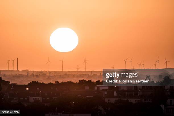 The sun rises behind wind turbines on July 07, 2018 in Berlin, Germany.