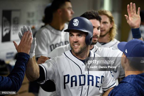 Matt Szczur of the San Diego Padres is greeted in the dogout during a baseball game against the Pittsburgh Pirates at PETCO Park on June 30, 2018 in...