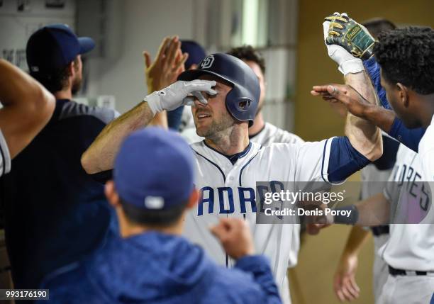 Matt Szczur of the San Diego Padres is greeted in the dogout during a baseball game against the Pittsburgh Pirates at PETCO Park on June 30, 2018 in...