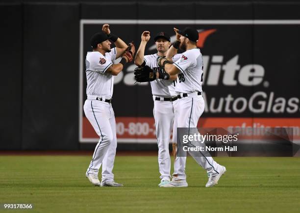 David Peralta, AJ Pollock and Steven Souza Jr of the Arizona Diamondbacks celebrate a 3-1 win against the San Diego Padres at Chase Field on July 6,...