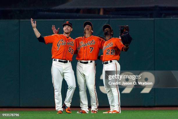 Austin Slater of the San Francisco Giants, Gorkys Hernandez and Andrew McCutchen celebrate after the game against the St. Louis Cardinals at AT&T...