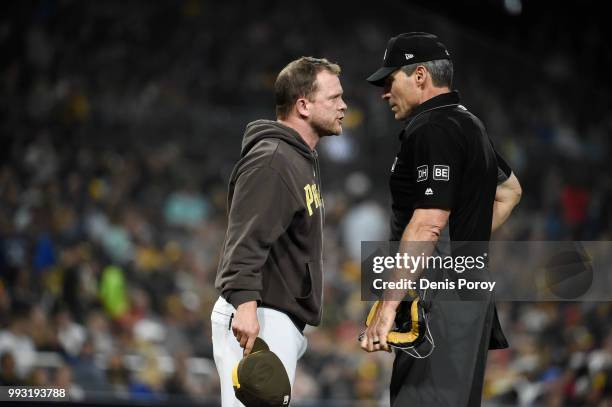 Andy Green of the San Diego Padres argues with home plate umpire Angel Hernandez after being thrown out of the game during the fourth inning of a...