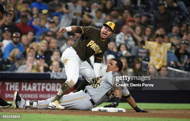 Jose Osuna of the Pittsburgh Pirates is tagged out at third base by Christian Villanueva of the San Diego Padres during the ninth inning of a...