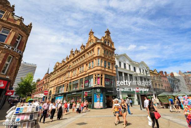 shoppers walking in a pedestrianised area of leeds - kelvinjay stock pictures, royalty-free photos & images
